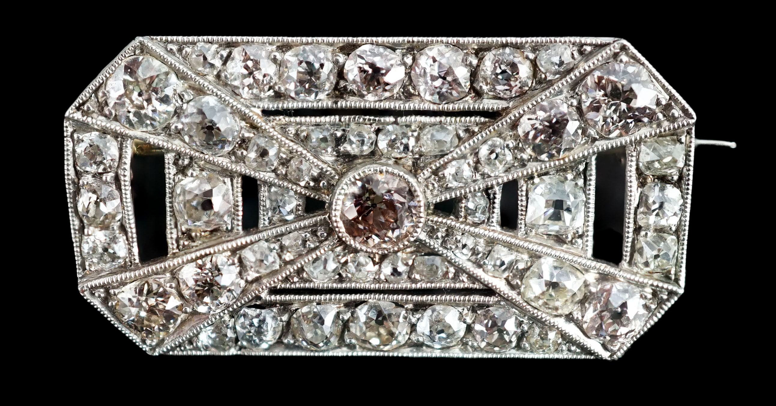 A 1930's/1940's Art Deco white gold, platinum and graduated diamond cluster millegrain set octagonal brooch